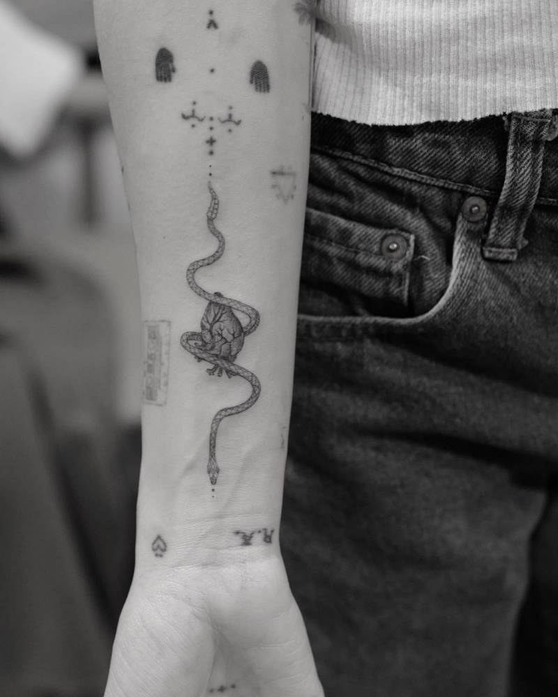 Single needle anatomical heart and snake tattoo on Zoë